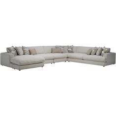 a large sectional couch with many pillows on the top and bottom corner, in white linen