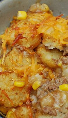 a bowl filled with potatoes and meat covered in cheese