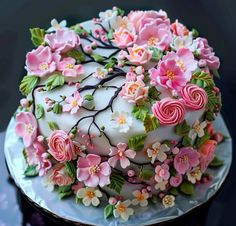 a cake decorated with flowers and leaves on a plate