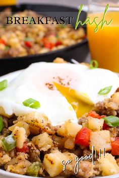 breakfast hashbrown with eggs and vegetables on a plate next to a glass of orange juice