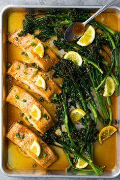 salmon and asparagus with lemon sauce in a pan