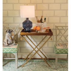 a dog sitting on a chair next to a table