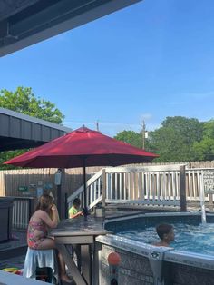 two people are sitting in an outdoor hot tub