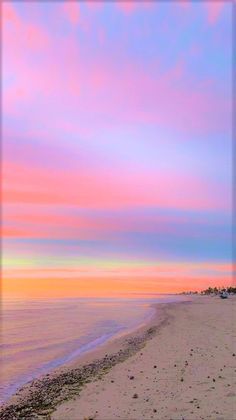 the beach is lined with footprints as the sun sets