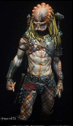 the predator action figure is shown in full body armor and headgear, with his hands on his hips