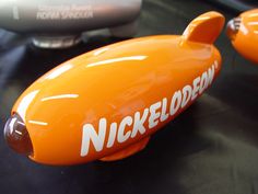 an orange toy submarine sitting on top of a table