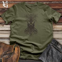 Embrace your uniqueness with our Entwined Roots Visage Cotton Tee! Featuring a one-of-a-kind design, this tee is perfect for those who don't take themselves too seriously. Made from comfortable cotton, it's the perfect blend of quirky and stylish. 100% Airlume combed and ring spun cotton Machine wash cold with like colors, dry low heat. *THIS PRODUCT WILL SHRINK* Lightweight, Classic unisex fit, Double-needle sleeve and bottom hem Boots & Jeans pictured are sold by Origin, a Pete Roberts & Jocko Fashion Forest, Roots Design, Boots Jeans, Military Green, Mother Earth, Tee Shop, Modern Fit, Full Sleeve, Unique Fashion