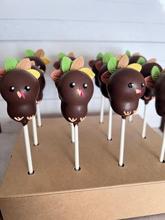 there are many cake pops decorated like turkeys on top of each other with leaves