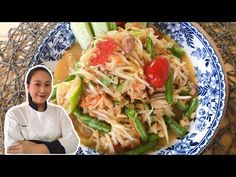 a woman is standing in front of a plate of food with vegetables and noodles on it