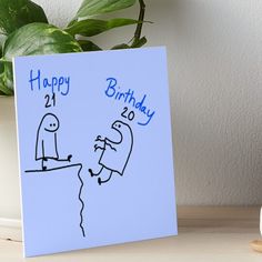 a birthday card with a drawing of two people on a cliff