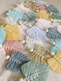 a bunch of tassels laying on top of a white table next to each other