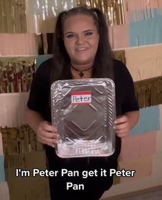 a woman is holding up a plastic pan