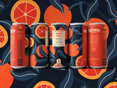 four cans of orange soda on a colorful background with leaves and flowers, all in different shapes and sizes