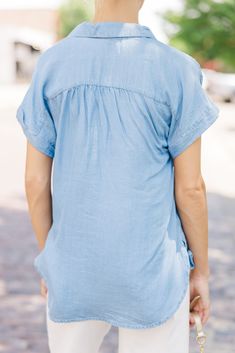 This chambray top is sure to make any outfit super cute! It's such a classic look. This chambray top is going to style easily with white shorts, jeans, or even printed midi skirts! Collared partial button down neckline Short sleeves No stretch Baileigh is wearing the small. Spring V-neck Top With Roll-up Sleeves, Spring Light Wash Collared Denim Top, Spring Light Wash Button-up Denim Top, Chic Spring Denim V-neck Top, Chic V-neck Denim Top For Spring, Chic Light Wash Tops With Pockets, Chic Light Wash Top With Pockets, Summer Medium Wash Button-up Denim Top, Chic Short Sleeve Denim Top For Day Out