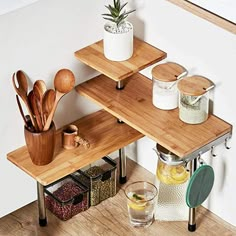 two wooden shelves with utensils and other kitchen items on top of each shelf