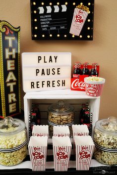 popcorn and sodas are on display at a movie themed party