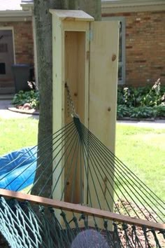 a hammock hanging from a tree next to a building