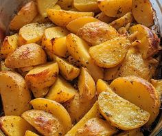 cooked potatoes in a pan with seasoning sprinkled on the top and bottom