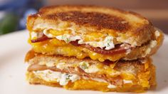 two grilled sandwiches stacked on top of each other with cheese and bacon in the middle