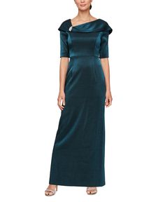 a woman wearing a long green dress with an asymmetrically shaped neckline