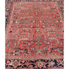 an antique persian rug with red and blue colors