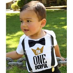 a young boy wearing a onederful shirt and bow tie