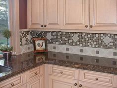 a kitchen with white cabinets and granite counter tops