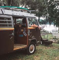 an old van is parked in the grass