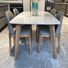 a glass table with four chairs around it