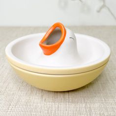 an orange and white object sitting on top of a bowl