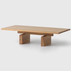 a wooden table sitting on top of a white floor