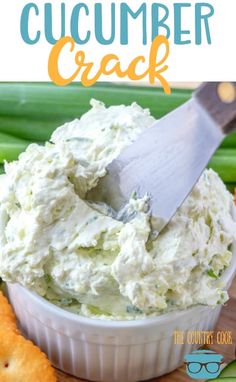 a close up of a plate of food with crackers and celery in the background