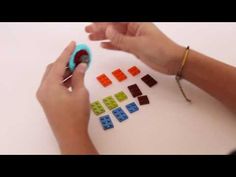 a person is playing with some legos on the white table and making it look like they are working on something