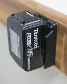 an electronic device attached to a wooden shelf