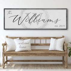 a wooden bench with pillows on it in front of a wall mounted sign that says the williamss