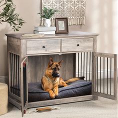 a dog laying on top of a bed in a room next to a wooden table