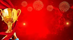 a man holding up a golden trophy over a red background with fireworks in the sky