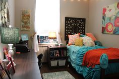 a bed room with a neatly made bed next to a desk and chair in front of a window