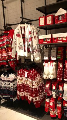 there are many sweaters on display in the store