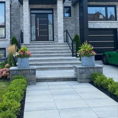 a house with two large planters on the front steps