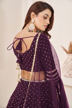 This is a 3-piece set. The set consists of sleeveless blouse with sequins & zari detailing, round neck teamed with flared matching lehenga and a dupatta. No of piece - 3 piece Color- Purple Fabric-Georgette Dupatta Fabric - Georgette Blouse Sleeves-Sleeveless Neck-Round Neck Lehenga length: Floor Length Washing instructions: Dry Clean Work- Zari & Sequins Print Detailing. Flared lehenga Comes with Dupatta Customizations: available. Please add your measurements in the 'order notes' box during che Festive Sleeveless Georgette Set, Sleeveless Anarkali Choli With Sequins, Sleeveless Georgette Choli For Eid, Sleeveless Sequined Lehenga For Diwali, Sleeveless Bollywood Anarkali Set For Party, Sleeveless Party Wear Sets With Resham Embroidery, Sleeveless Resham Embroidery Party Wear Sets, Sleeveless Sequined Anarkali Set For Party, Festive Sleeveless Party Wear Sharara