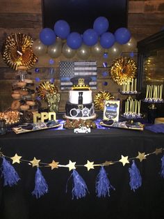 a table topped with a cake and balloons