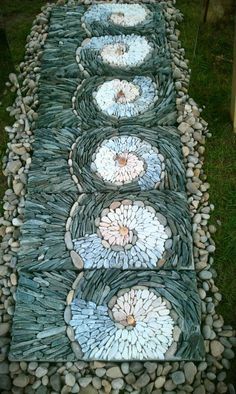 a garden path made out of stones and pebbles