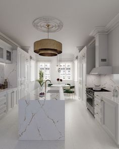 a white kitchen with marble counter tops and an island in front of the stove top