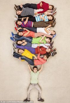 a group of people standing in the shape of a tree