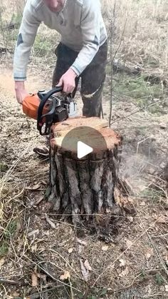 a man is using a chainsaw to cut down a tree