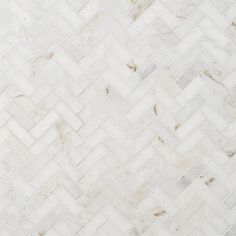 a white marble herringbone tile pattern