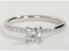 a white gold engagement ring with diamonds on it