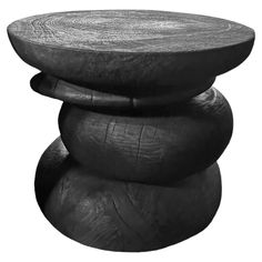 a black and white photo of three stacked round stools on top of each other