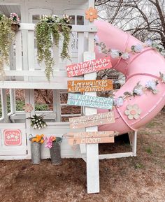 a pink slide sitting next to a wooden sign